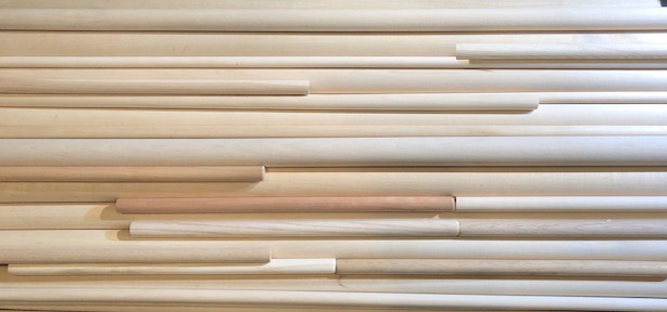 Stack of Various Round Wooden Dowels